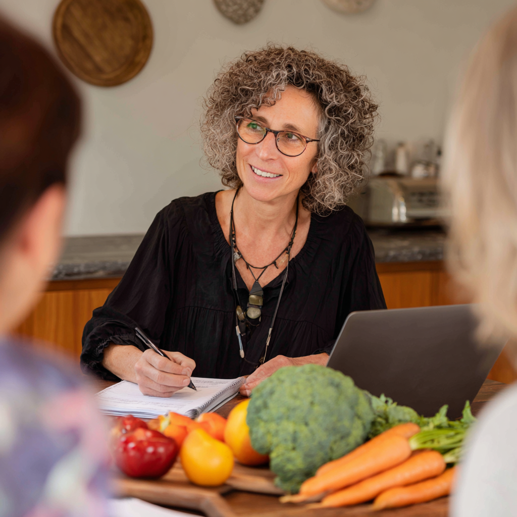 Professional nutritionist working with middle-aged clients on personalized meal planning